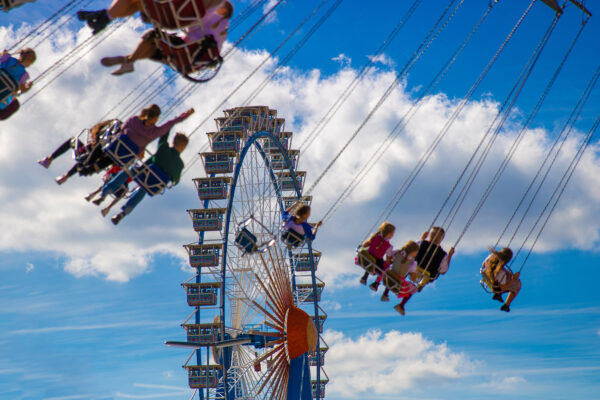 Oktoberfest Ferris wheel and carousel in motion